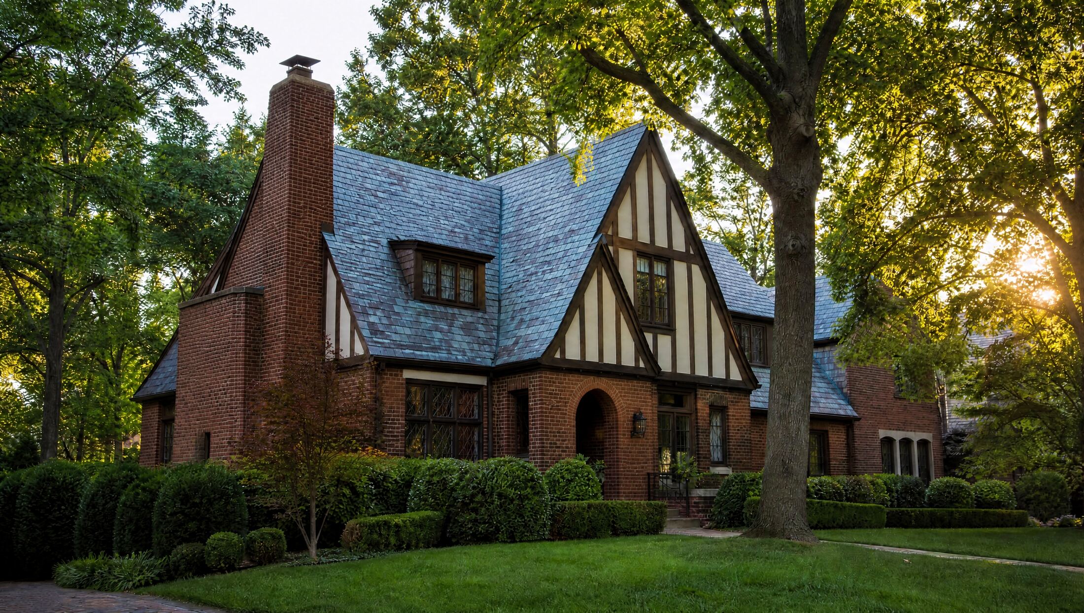 Illustration of a brick Tudor home on a tree-lined street, typical of Birmingham, Michigan