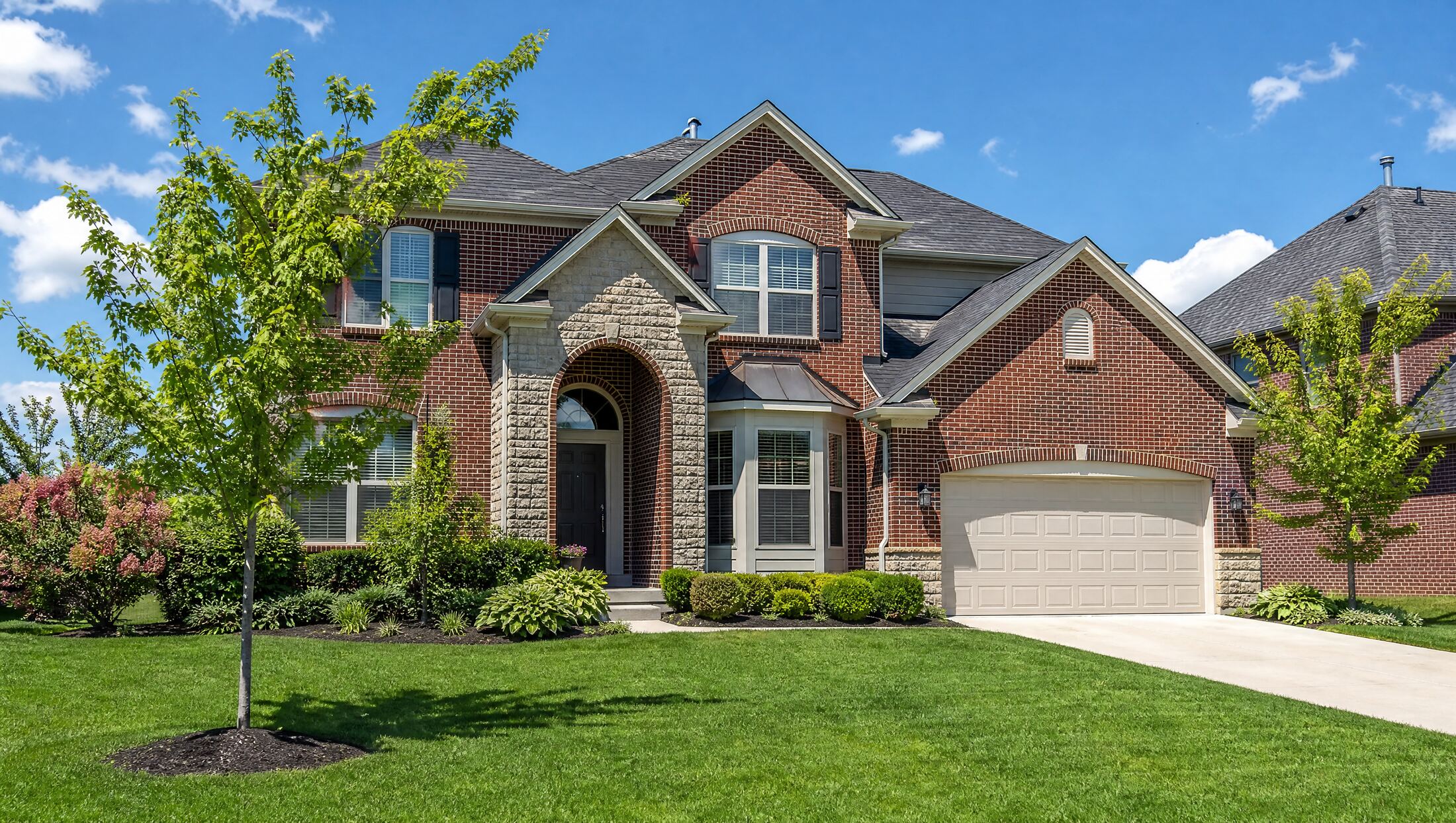 Illustration of a brick and stone family home, typical of Macomb County, Michigan