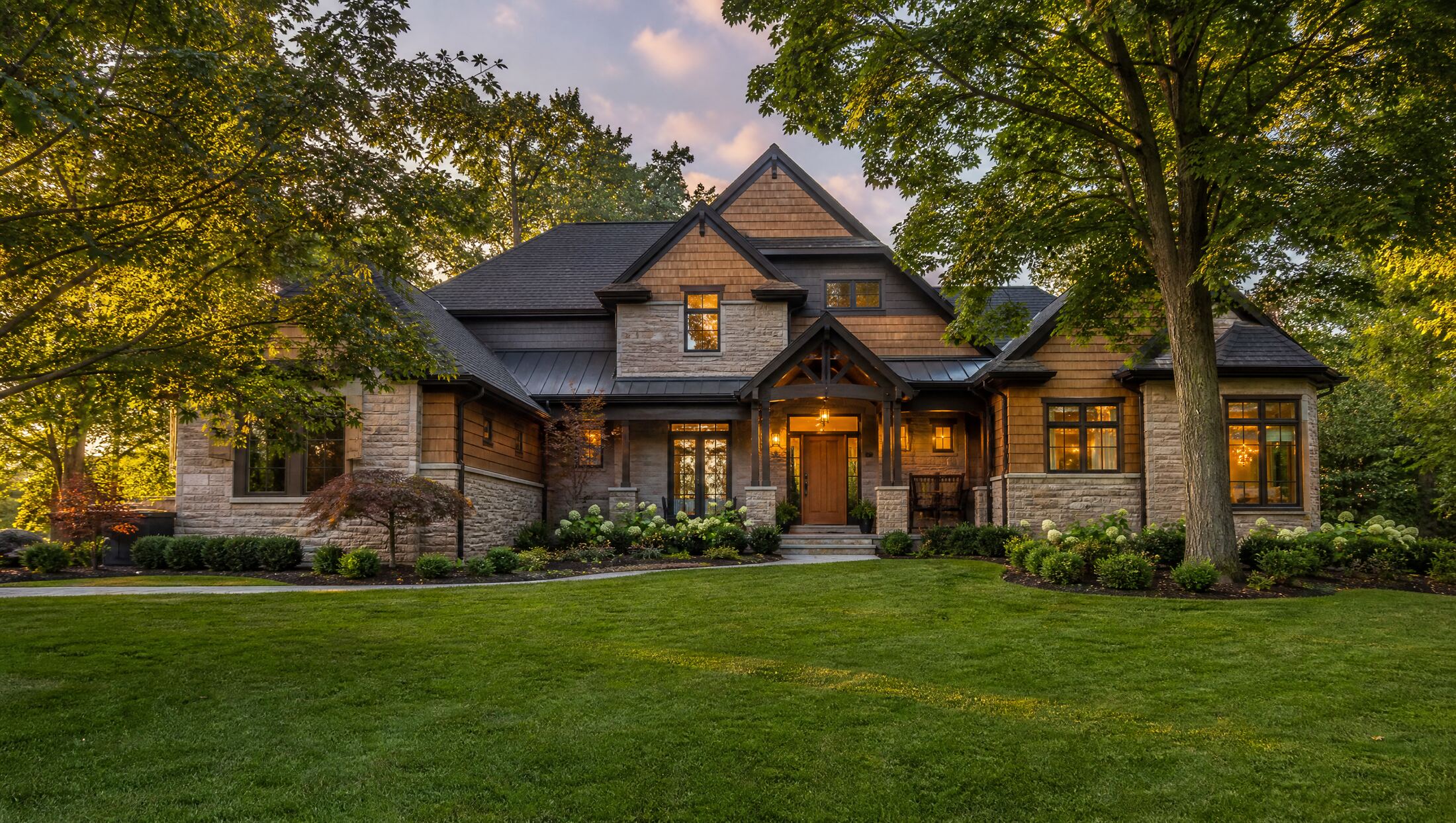 Illustration of a stone and cedar craftsman home at dusk, typical of Novi, Michigan
